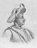 Tipu Sultan (Kannada: ಟಿಪ್ಪು ಸುಲ್ತಾನ್, Urdu: سلطان فتح علی خان ٹیپو) (November 1750, Devanahalli – 4 May 1799, Seringapatam), also known as the Tiger of Mysore, was the de facto ruler of the Kingdom of Mysore. He was the son of Hyder Ali, at that time an officer in the Mysorean army, and his second wife, Fatima or Fakhr-un-Nissa. He was given a number of honorific titles, and was referred to as Sultan Fateh Ali Khan Shahab, Tipu Saheb, Bahadur Khan Tipu Sultan or Fatih Ali Khan Tipu Sultan Bahadur.<br/><br/>

During Tipu's childhood, his father rose to take power in Mysore, and Tipu took over rule of the kingdom upon his father's death. In addition to his role as ruler, he was a scholar, soldier, and poet. He was a devout Muslim but the majority of his subjects were Hindus. At the request of the French, he built a church, the first in Mysore. He was proficient in many languages. In alliance with the French in their struggle with the British, and in Mysore's struggles with other surrounding powers, both Tipu Sultan and Hyder Ali used their French trained army against the Marathas, Sira, rulers of Malabar, Coorg, Bednur, Carnatic, and Travancore. He won important victories against the British in the Second Anglo-Mysore War, and negotiated the 1784 Treaty of Mangalore with them after his father died the previous year.<br/><br/>

He engaged in expansionist attacks against his neighbours, and harshly put down rebellions within his territories, deporting whole populations into confinement in Seringapatam. He remained an implacable enemy of the British, bringing them into renewed conflict with an attack on British-allied Travancore in 1789. In the Third Anglo-Mysore War Tipu was forced into a humiliating peace, losing a number of previously conquered territories, such as Malabar and Mangalore. He sent embassies to foreign states, including the Ottoman Empire and France, in an attempt to rally opposition to the British. In the Fourth Anglo-Mysore War the combined forces of the British East India Company and the Nizam of Hyderabad defeated Tipu and he was killed on 4 May 1799, defending the fort of Seringapatam.<br/><br/>

Tipu's treatment of conquered subjects, non-Muslims, and prisoners of war, were controversial, and continue to be a subject of debate today. He introduced a number of administrative and military innovations to Mysore (including the expansion of rocket technology), and introduced and promoted a more widespread use of Persian and Urdu languages in southern India.